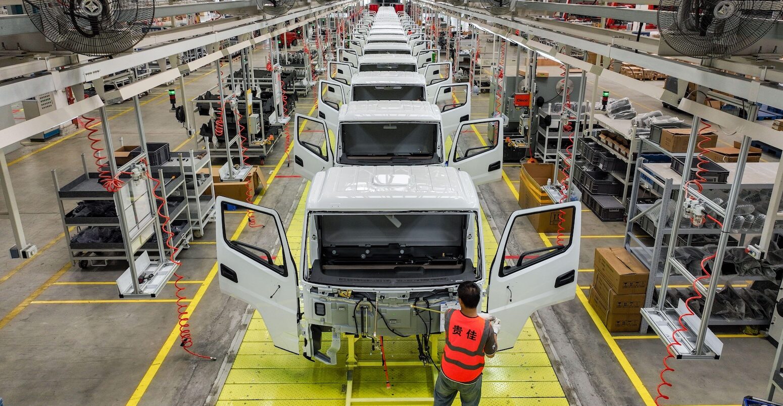 An employee operates at an assembly line of new energy light trucks in Guizhou, China.