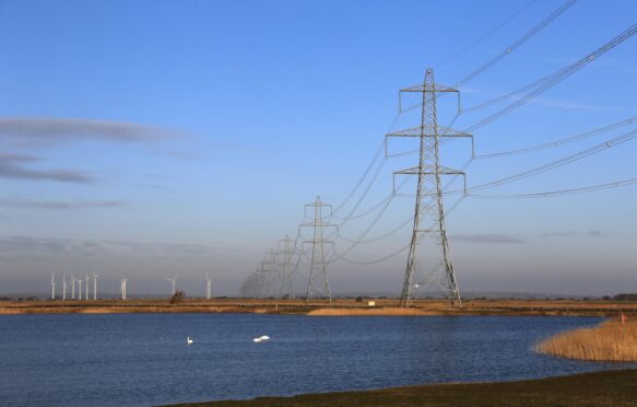 Pylons and wind farm in Dungeness, Kent, UK.