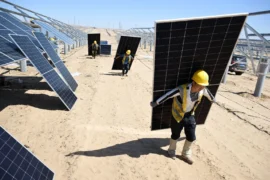 Workers install solar photovoltaic panels in Yinchuan, China.